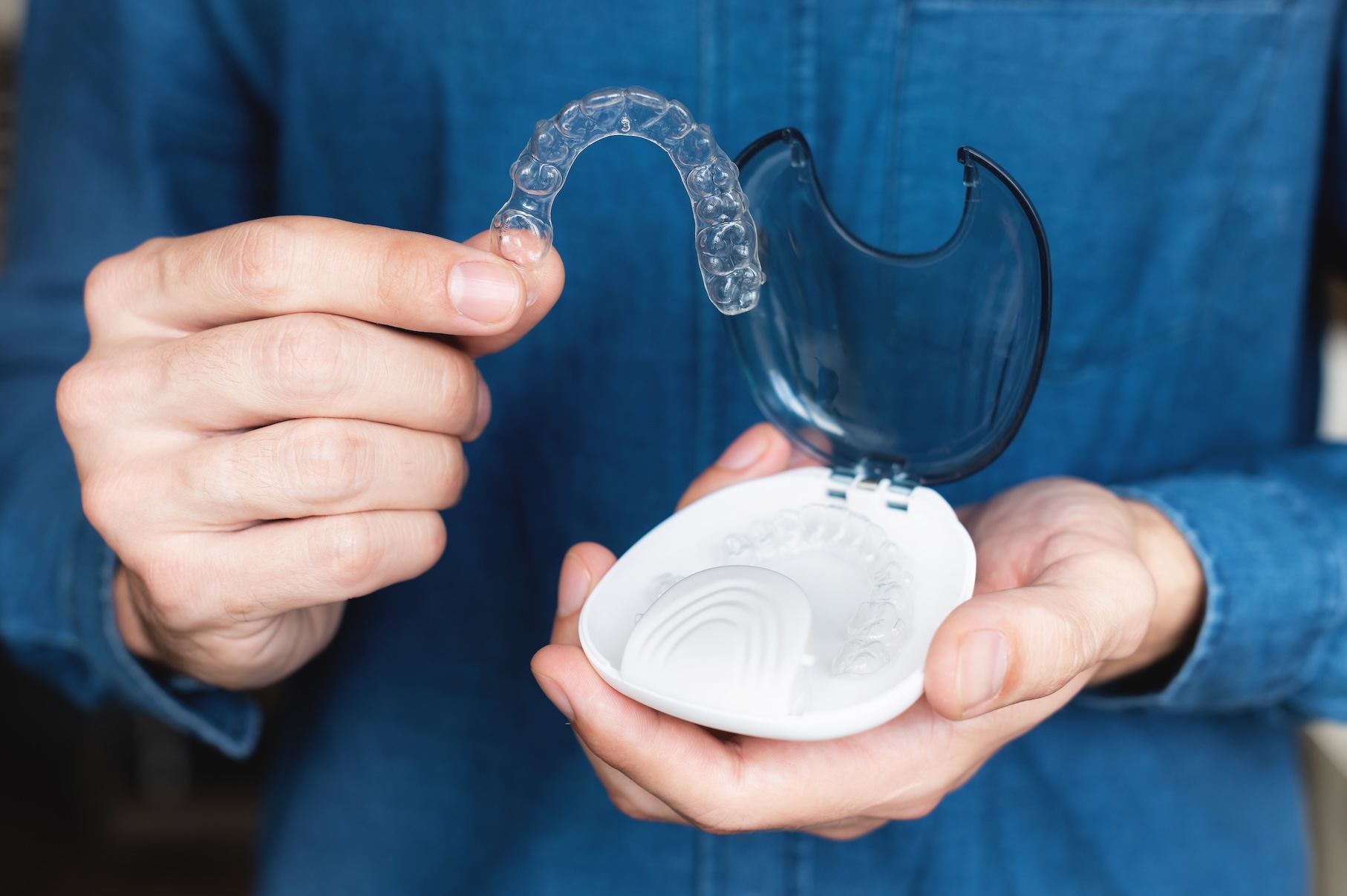 A man holding an invisible aligner product
