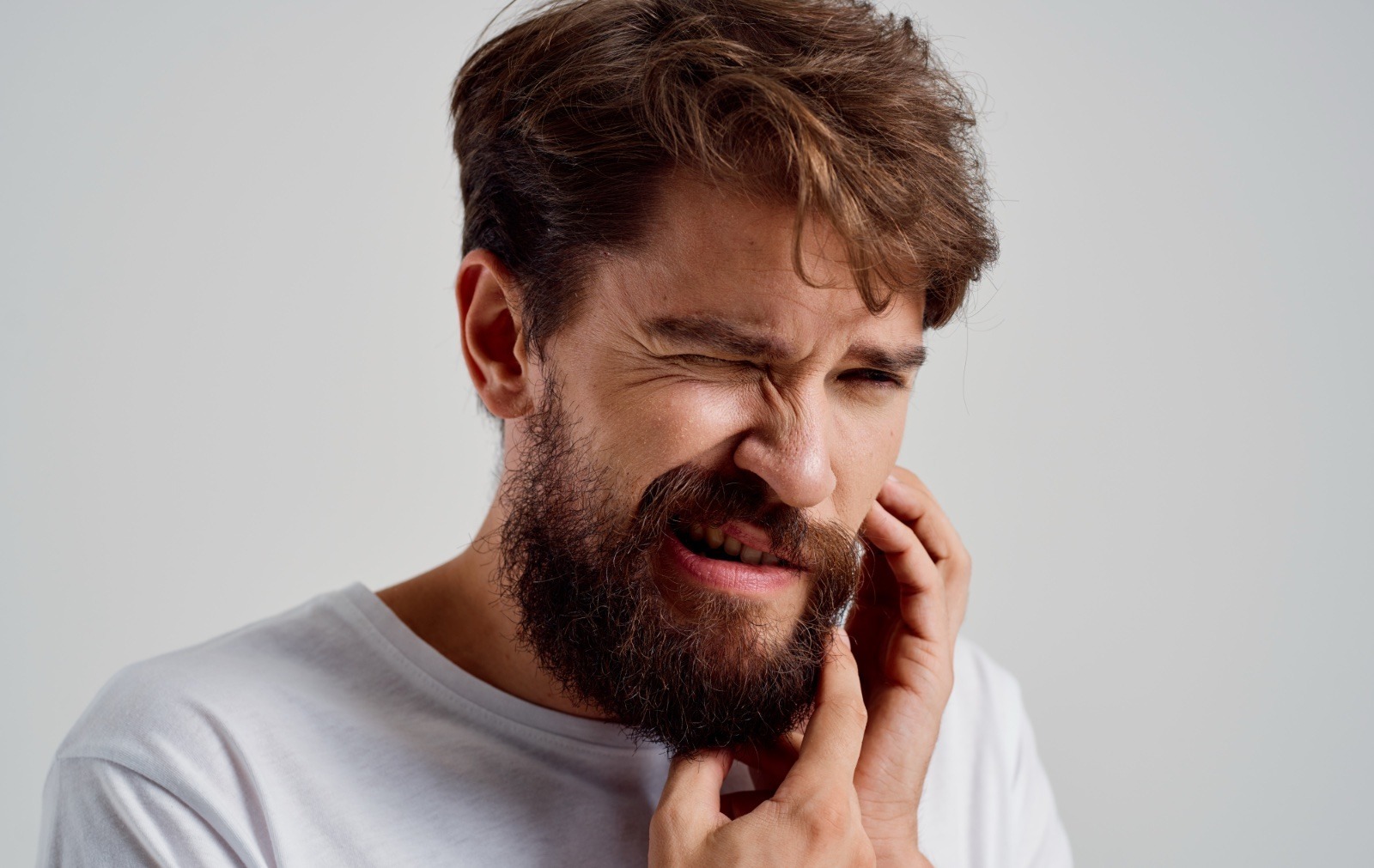 bearded man holding his face toothache. High quality photo