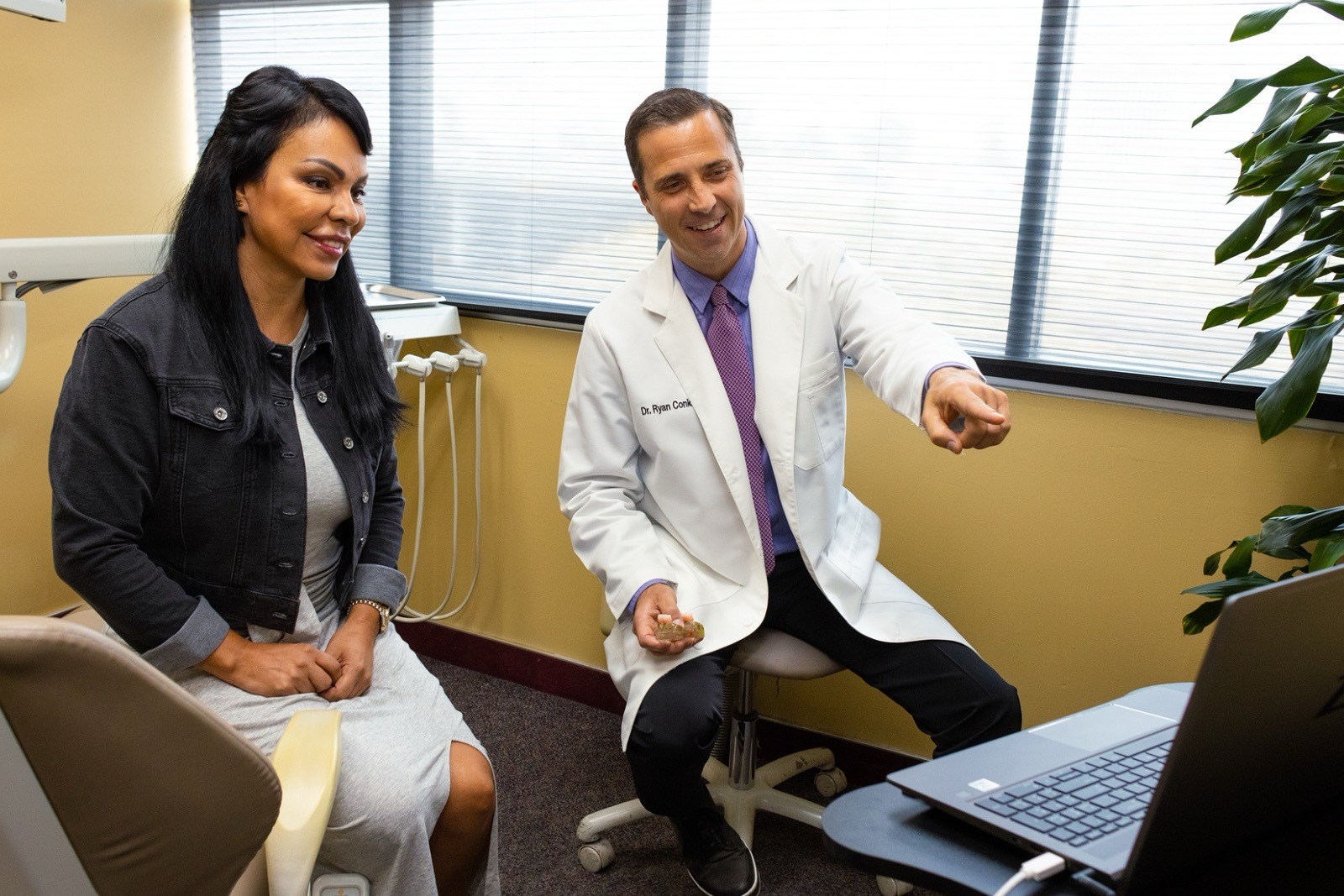 Dr. Conkle shows a patient a treatment on a screen
