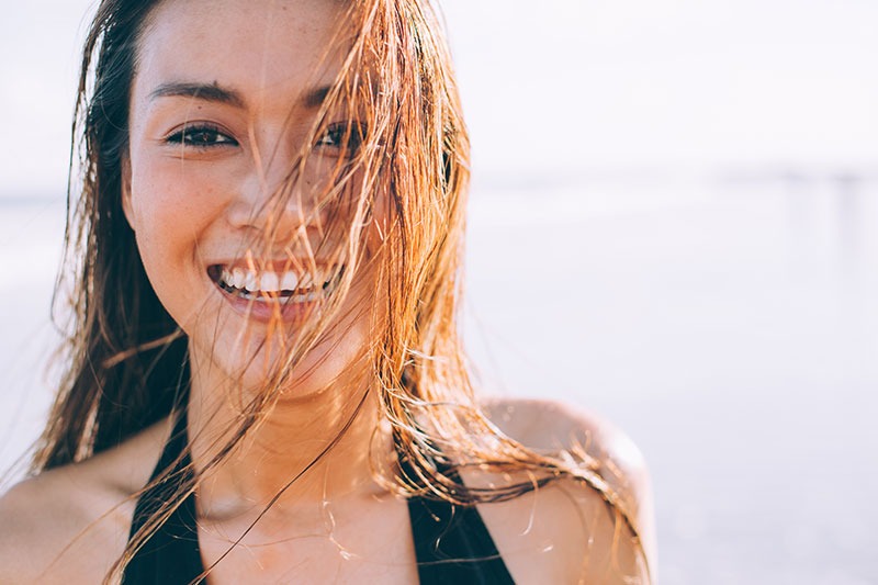 Smiling woman at a beach