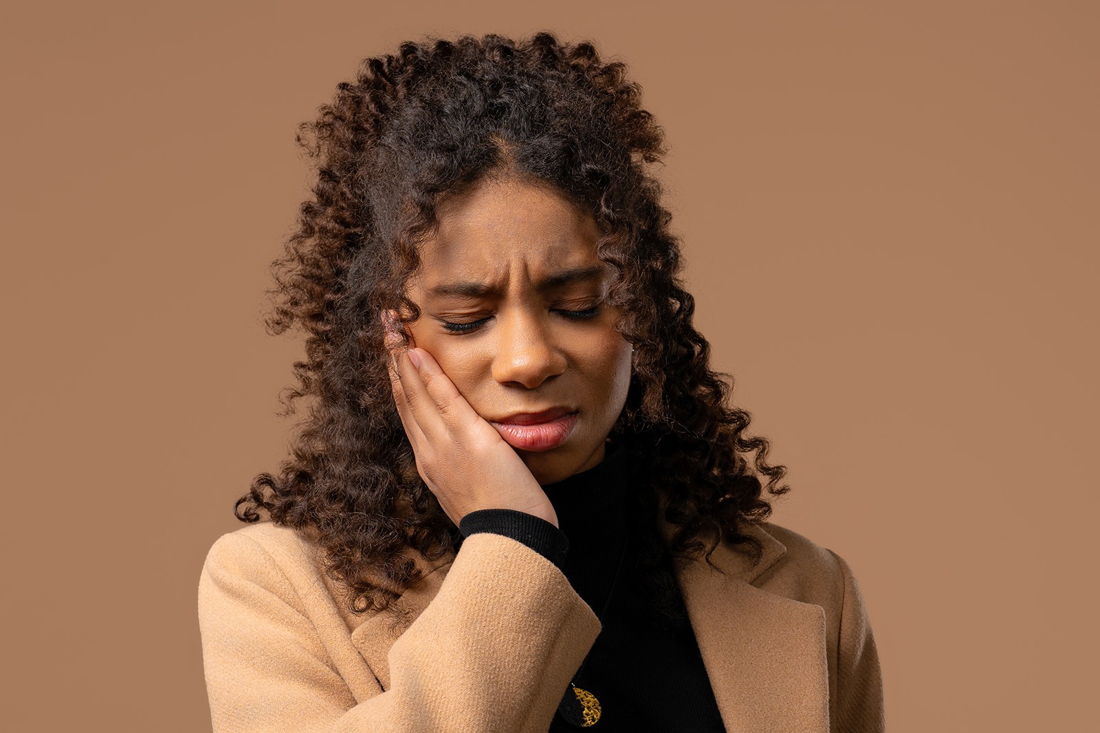 A woman experiencing tooth pain