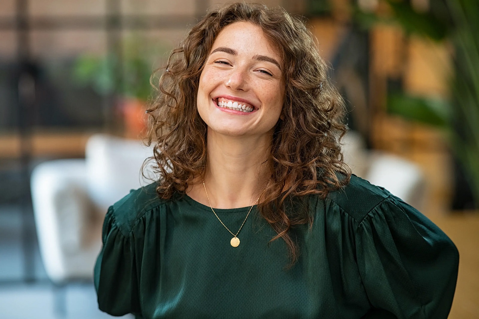 A woman smiling at an indoor bldg